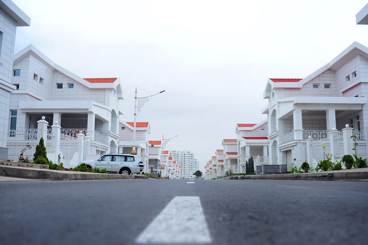 about-bg Modern luxury houses line a calm street in Ashgabat, Turkmenistan.